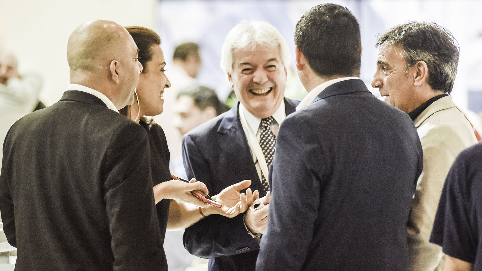 group of people talking and laughing at Automechanika BA